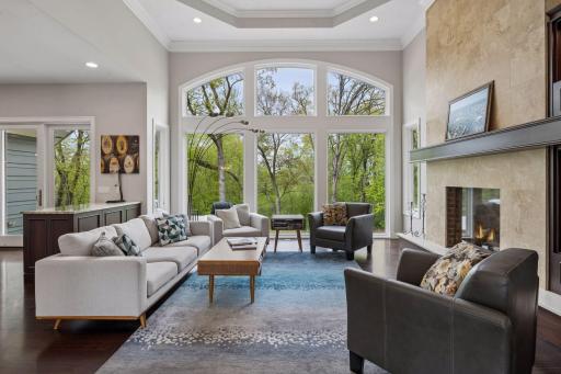 The archways are reflected throughout the main level, from the ceiling of the entryway, to the doorways, and even the floor-to-ceiling, 12-foot high windows of the great room.