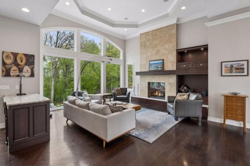 The great room boasts Brazilian cherry flooring, a travertine fireplace surround, gorgeous lighted built-ins and more.