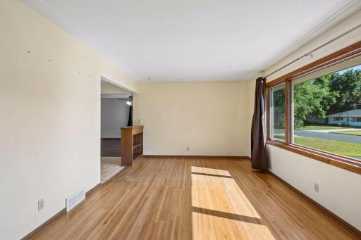 Main floor living rom is bright and sunny with hfloors, large picture window