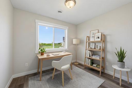 The second bedroom features durable LVP flooring. Photo has been virtually staged.