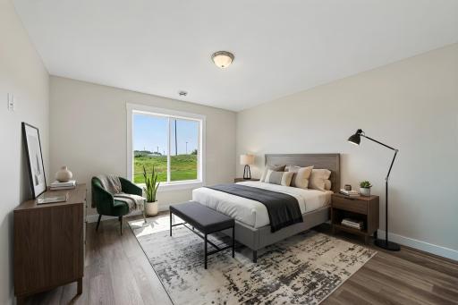 The primary bedroom features a private full ensuite bathroom and a walk-in closet. Photo has been virtually staged.