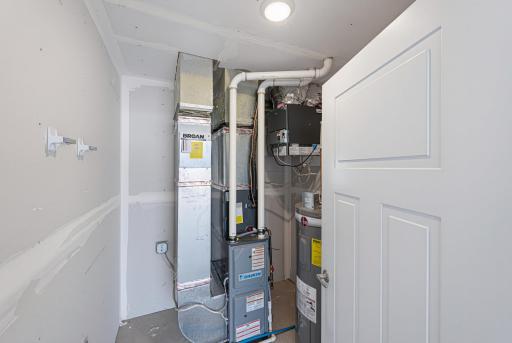 Mechanicals include a forced air furnace with an air exchanger, an electric water heater, and an owned water softener.