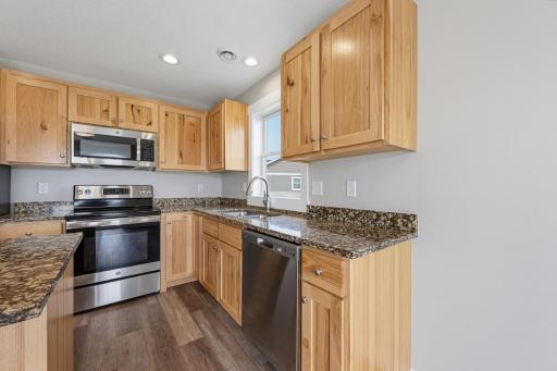 The kitchen features granite countertops and a full suite of S.S. appliances.