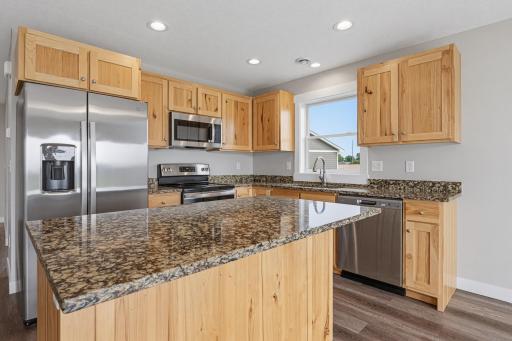 The kitchen features a center island and granite countertops.