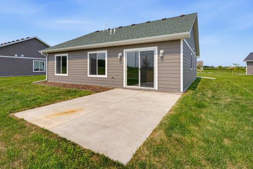 A concrete patio is situated in the backyard.