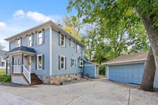 Door with the stairs is entrance to the upper unit. Main floor unit entrance is in the back. 2 car detached garage with ample parking space