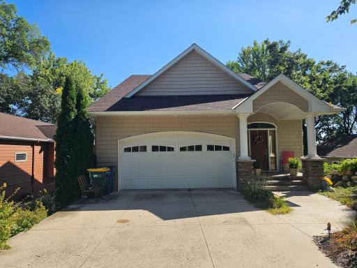 2 stall garage has additional storage underneath. Storage is accessible from smaller garage door on side of home or from basement.