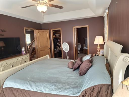 Primary suite has tray ceiling and features a large walk-in closet.