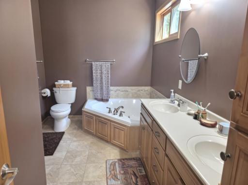 Primary bath has dual sinks with great natural lighting.