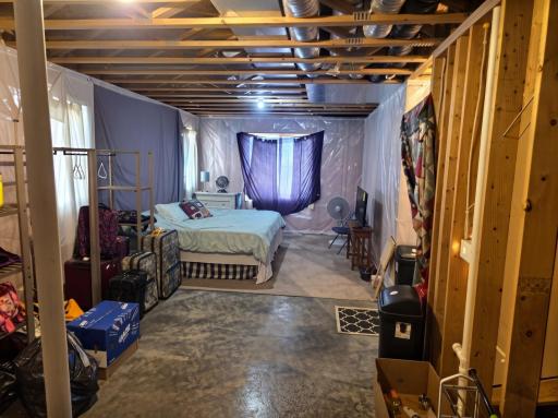 Unfinished basement bedroom area has plenty of room to create additional primary suite with lake views.
