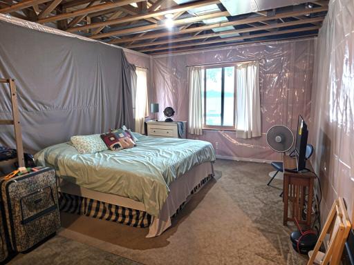 Unfinished basement bedroom area has plenty of room to create additional primary suite with lake views.