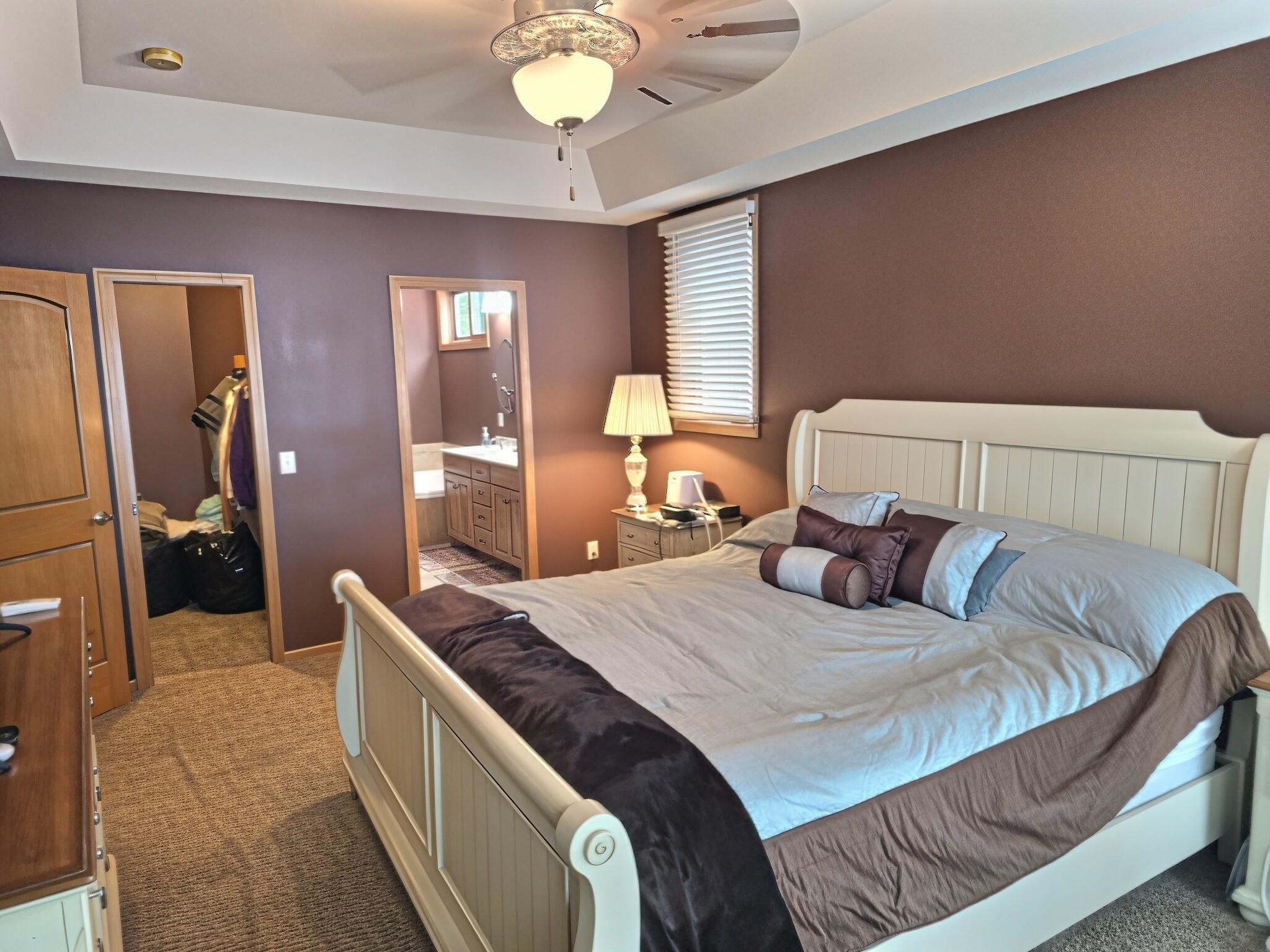 Primary suite has tray ceiling and features a large walk-in closet.