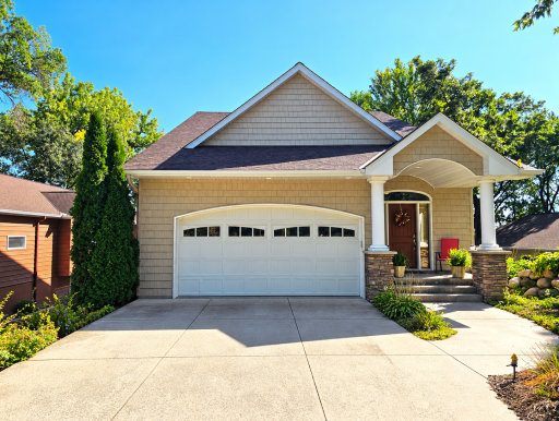 2 stall garage has additional storage underneath. Storage is accessible from smaller garage door on side of home or from basement.