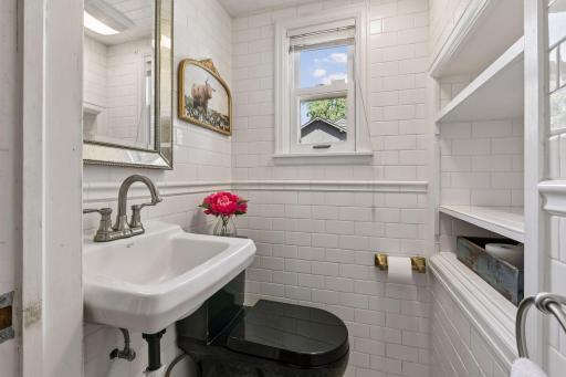 Main floor half bath with beautiful tile floors and built ins.