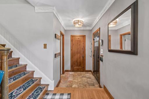 Entry with tiled flooring and coat closet.