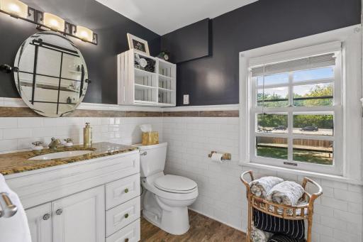 Updated upper level full bath looks out to backyard.