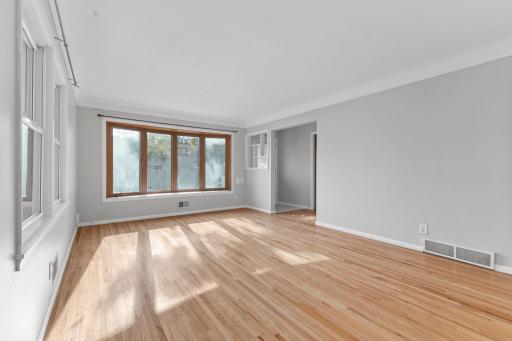 Large bay window fills the living room with natural light.