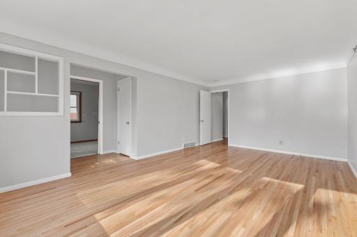 Spacious main-level room with hardwood floors and a comfortable, open feel.