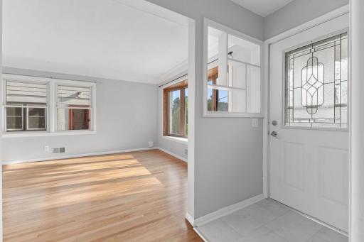 Welcoming interior transition with classic trim, sunny windows, and clean neutral finishes.