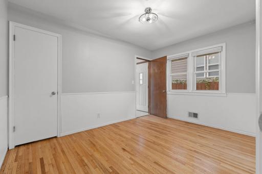 Another bedroom option with natural light and flexible furniture placement.