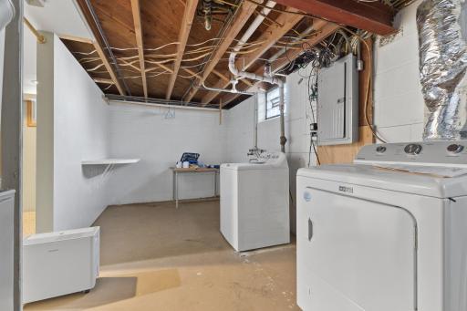 Laundry area with utility sink and helpful storage potential.