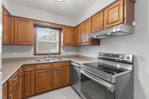 Kitchen detail with wood cabinetry, tile floor, and useful prep space.