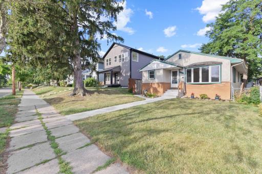 Wider front approach with sidewalk views and neighborhood context.