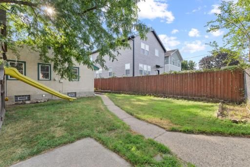 Fenced backyard setting with room for play, gardening, or relaxing outside.