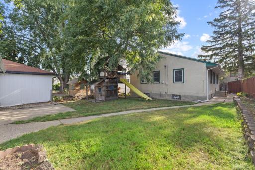 Backyard view with mature trees and space to enjoy the outdoors.