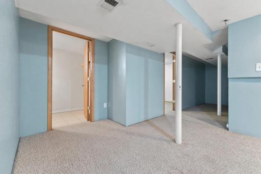 Flexible basement space with multiple zones for storage, hobbies, or future use.