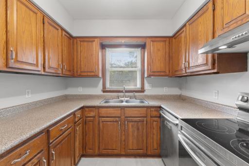 Warm wood cabinetry and a practical kitchen workspace ready for everyday cooking.