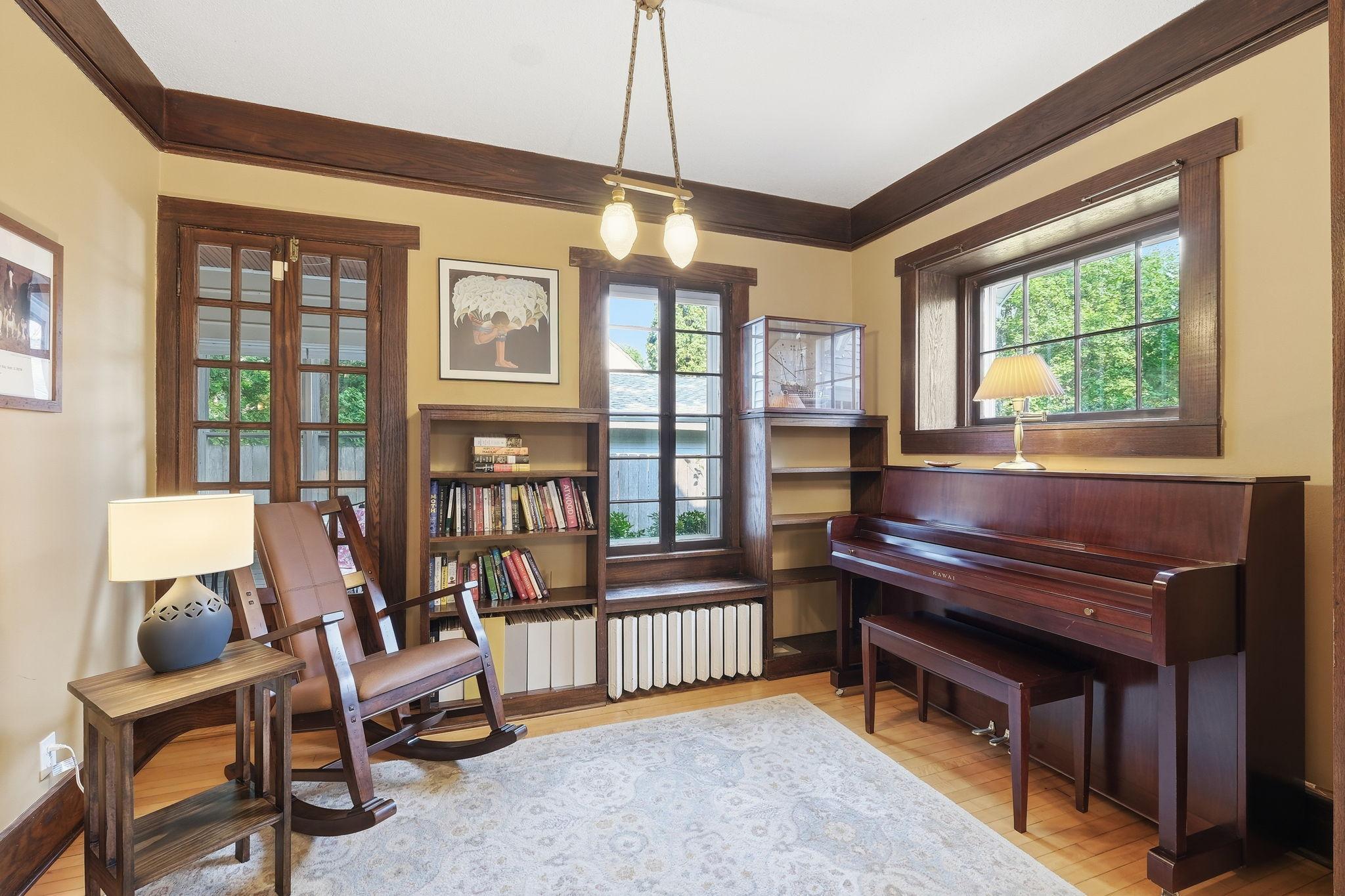The sitting room is adorned with windows and look at the gorgeous cove molding!