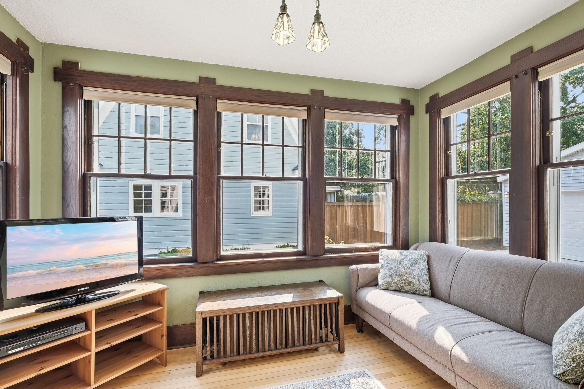 This area is the perfect family sun room or office space. Oh my gosh to the windows!