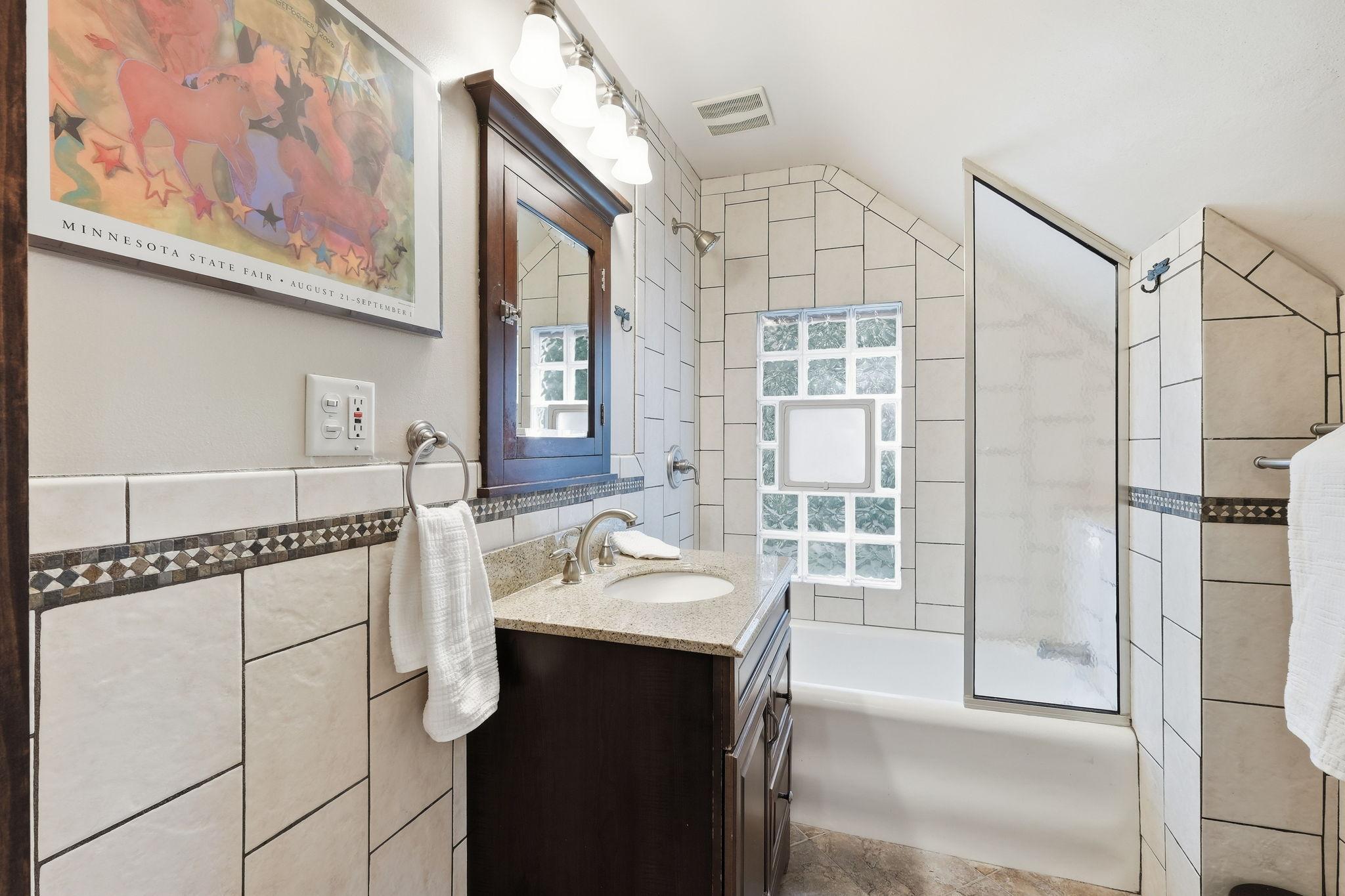 The upper level bath has been remodeled and is charming too.