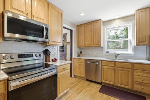 Great cabinet and counter space in this cute kitchen.