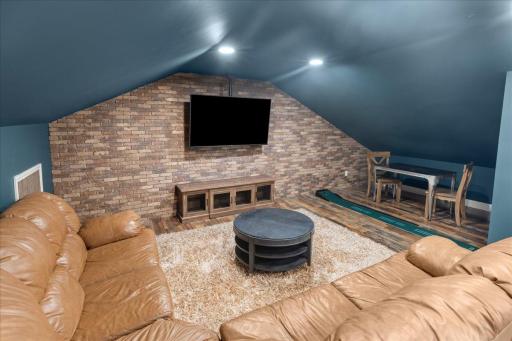 The finished loft space over the garage is the perfect space to watch the big game or host game night!