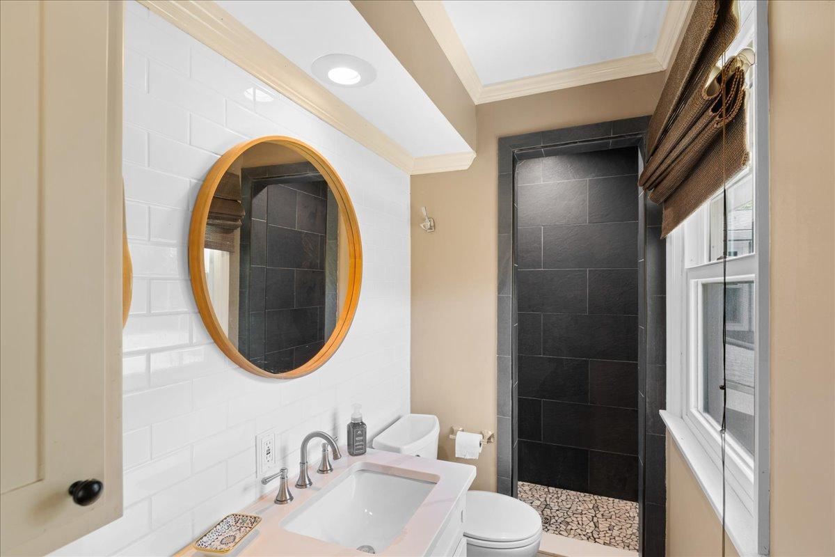 Private 3/4 bathroom with tiled walk-in shower.