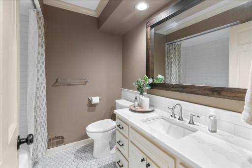 Upper level full bathroom features amazing tilework and large vanity.