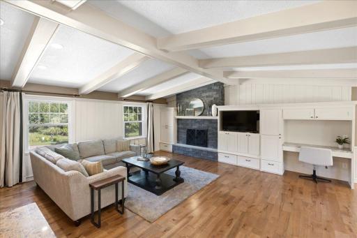 Family room includes hardwood floors, vaulted ceilings, wood burning fireplace and great built-in storage.