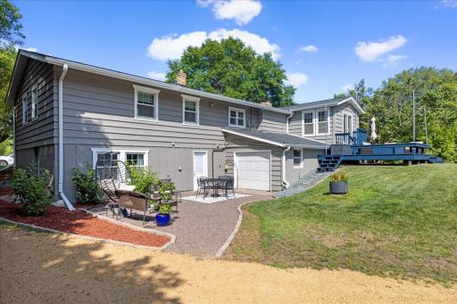 Another view of the patio area and 3rd garage bay on the backside of the home.