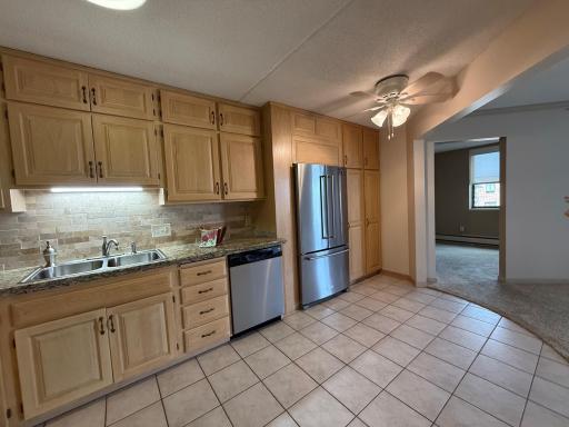 2601 Kenzie Terrace 528 kitchen tile backsplash,tile floor, entrance to Den. Ceramic tile floor, double stainless sink and newer stainless Refrigerator and dishwasher.