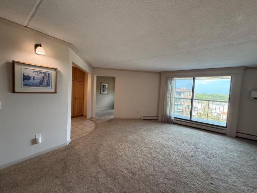 Spacious living room offers beautiful exterior views from 5th floor which is highest floor in building. Large patio door lets in plent of natural light too! Access the double covered balcony thru this patio door. New mini-split A/C is super quiet