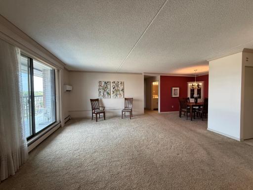 Another view of the living room looking toward the formal dining room. to the rightin foyer is large front entry closet .