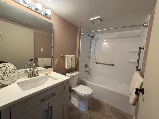 Updated main floor bathroom with tub/shower with two grab handles for safety. Newer bath exhaust fan to get rid of the moisture.