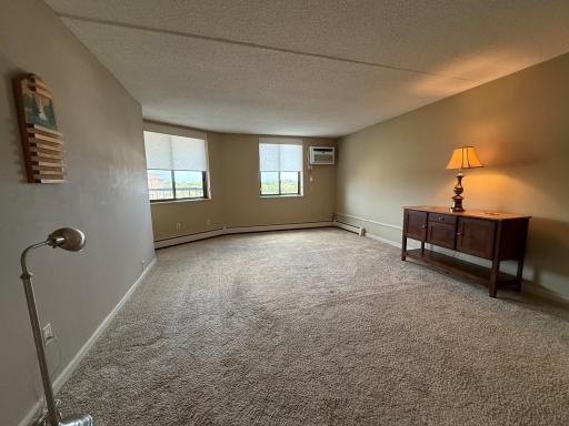 Spacious Owners Suite with awesome 5th floor views!! The window blinds are included. Wall A/C unit has remote control for extra convenience.