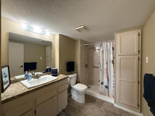 Updated Owners Suite Bath with granite counter ,walk in shower with grab bars for safety and large linen closet.