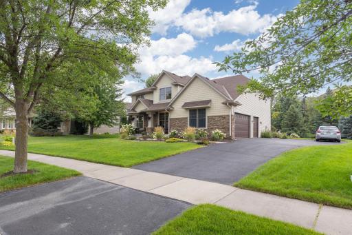 The expansive driveway provides plenty of parking and easy access to the attached garage.