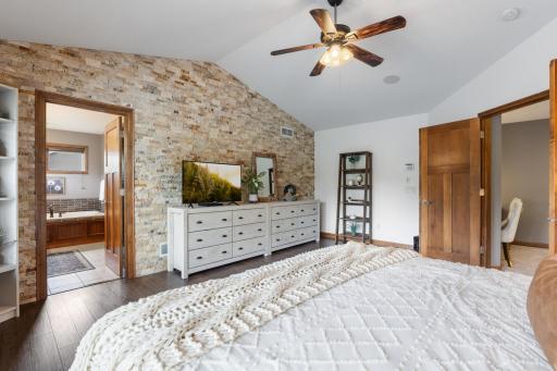 Newly remodeled primary suite has a stone feature wall