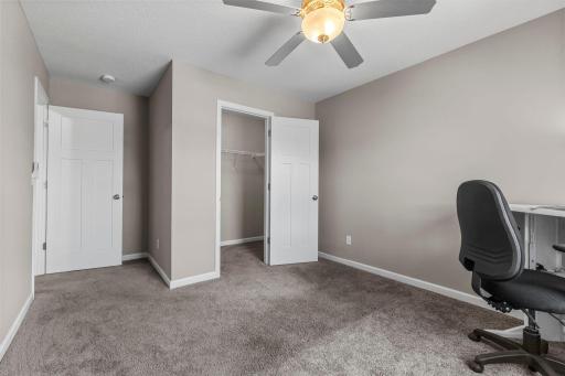 Upper-level bedroom or home office with walk-in closet