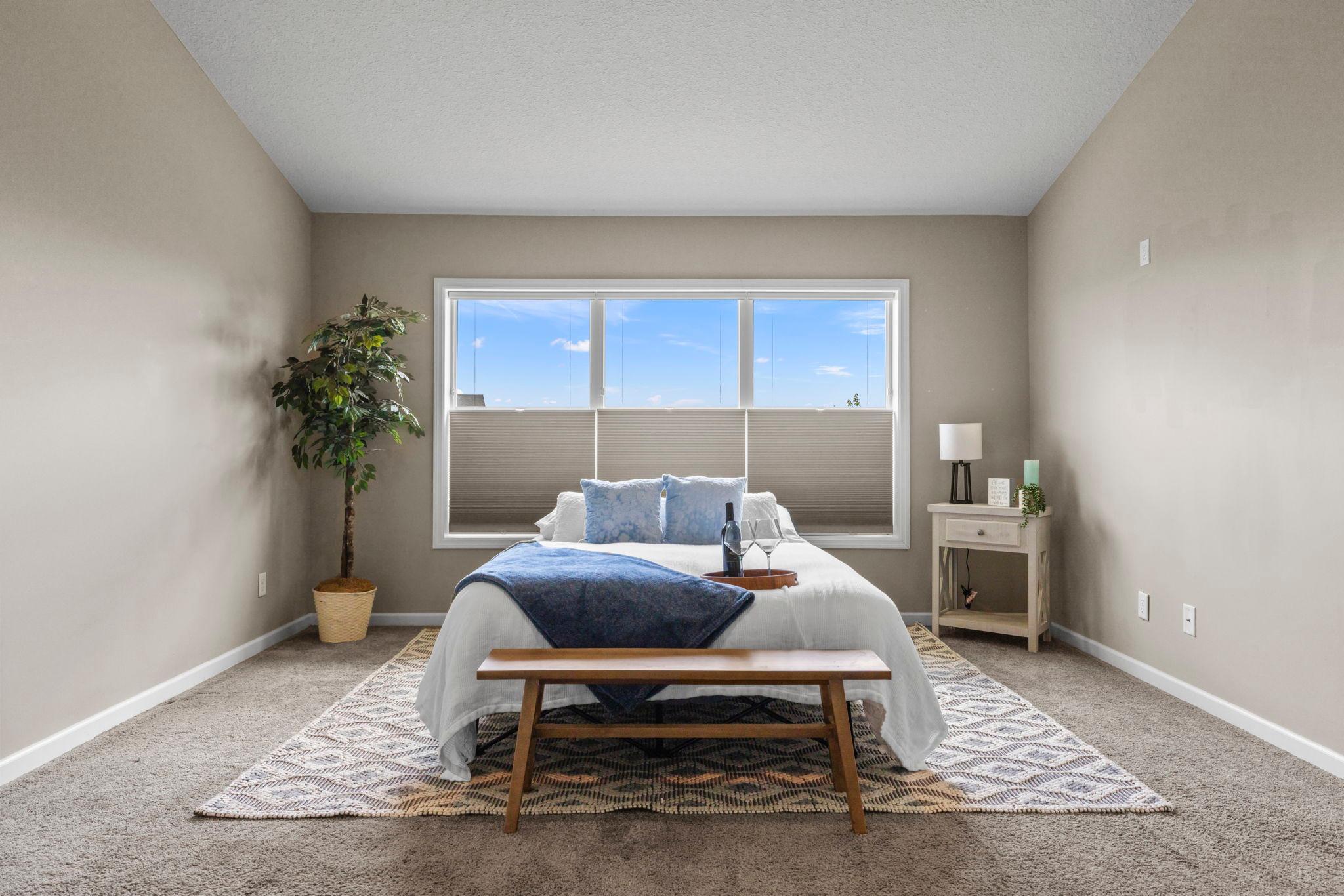 Primary bedroom with custom Hunter Douglas blinds